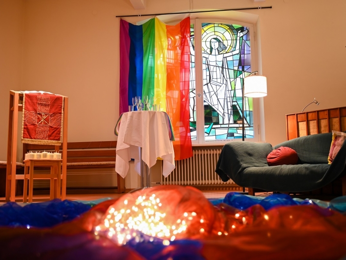Mit Regenbogenflagge geschmücktes Fenster in der Kapelle